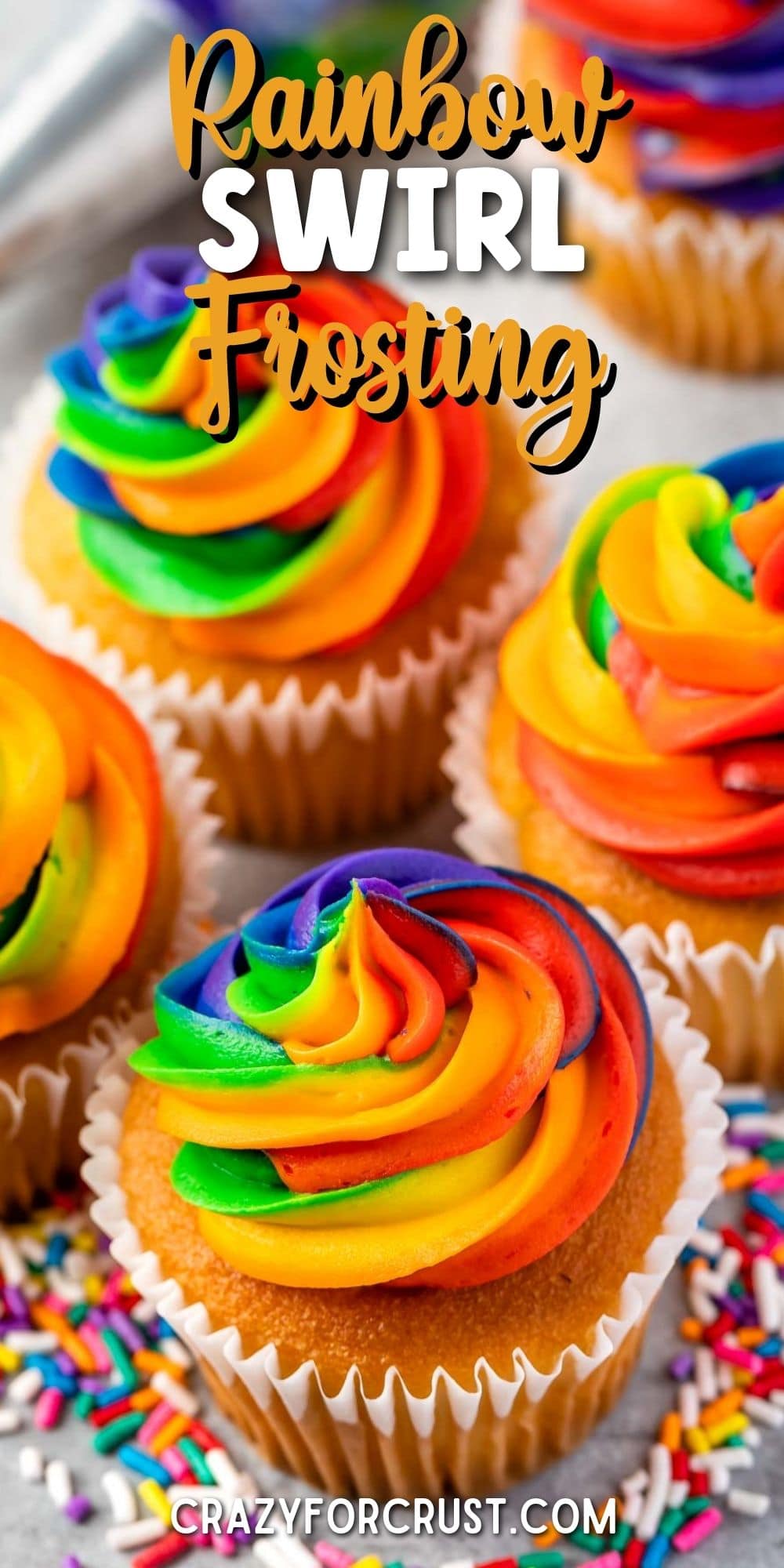 Overhead shot of rainbow swirl frosting on top of vanilla cupcakes with recipe title on top of image