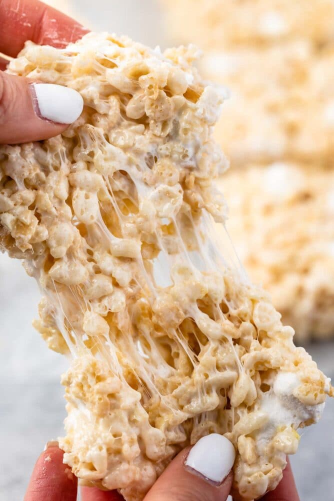 Rice krispie treat being pulled apart to show the ooey gooey marshmallow