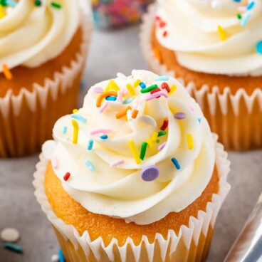 cupcake with vanilla frosting and sprinkles