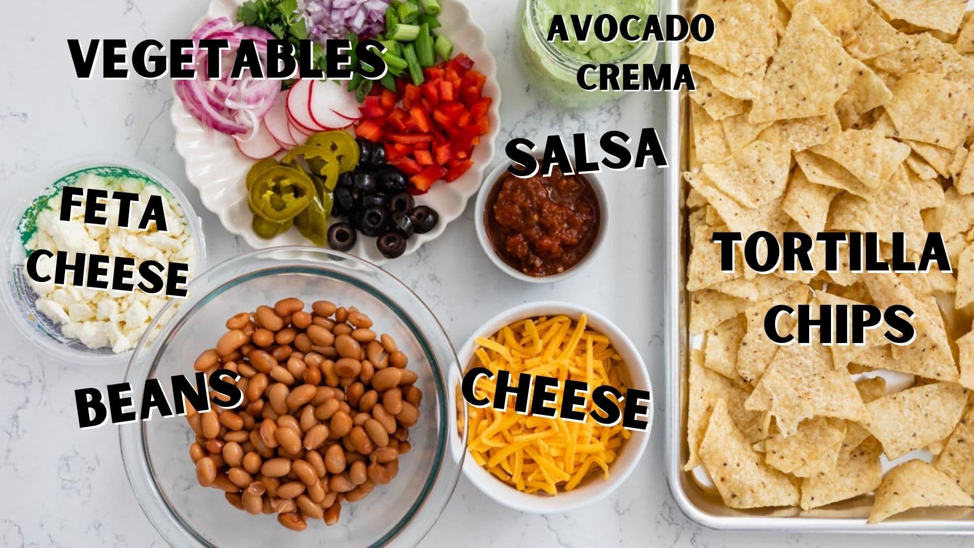 Overhead shot of all ingredients needed for veggie sheet pan nachos