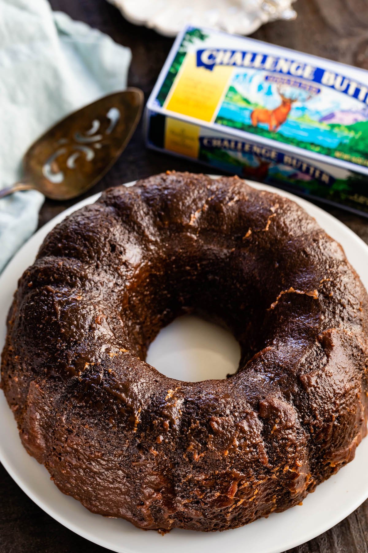 full brown bundt cake on a white plate