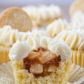 cupcake with white frosting cut in half to show apple filling