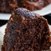 slice of chocolate cake on a white plate with words on the photo