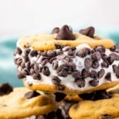 an ice cream sandwich with three chocolate chips on top and many chocolate chips around the side of the sandwich