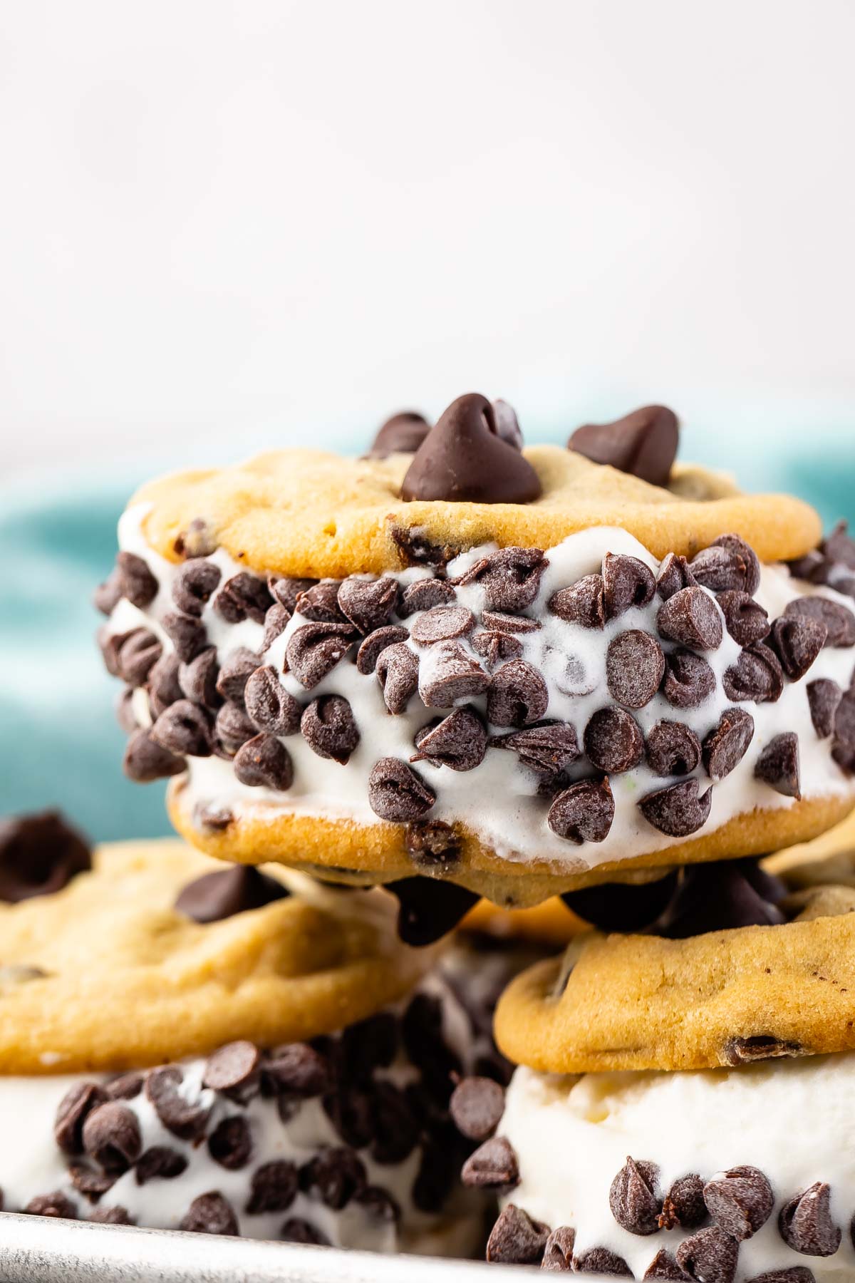 an ice cream sandwich with three chocolate chips on top and many chocolate chips around the side of the sandwich