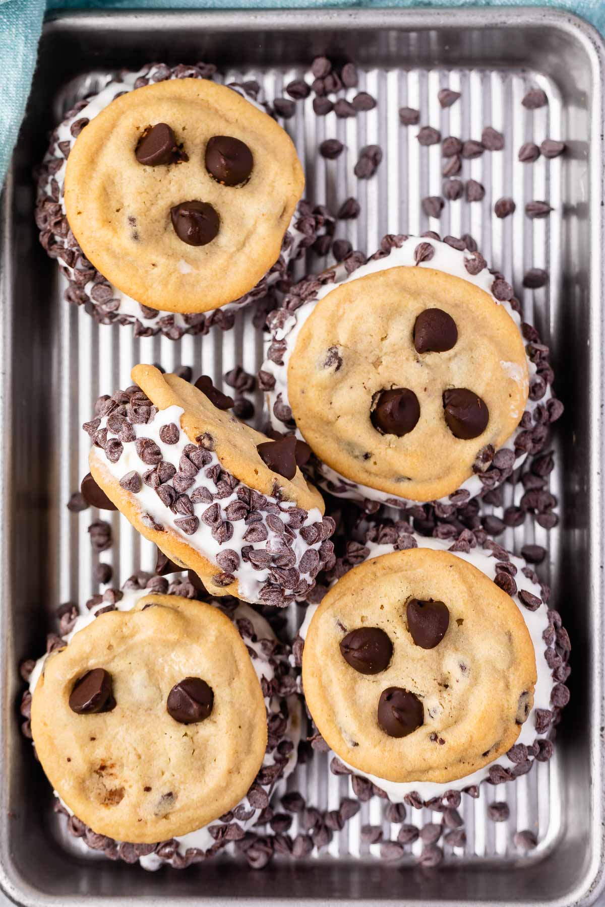 multiple ice cream sandwiches with chocolate chips on the ice cream