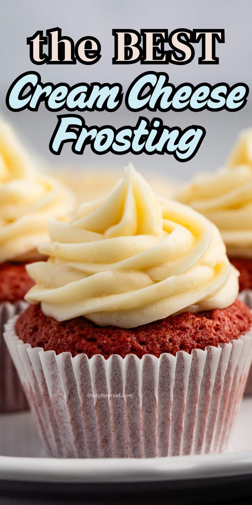 Close-up of red velvet cupcakes topped with rich, swirled cream cheese frosting, with text above reading the BEST Cream Cheese Frosting in bold and script fonts.