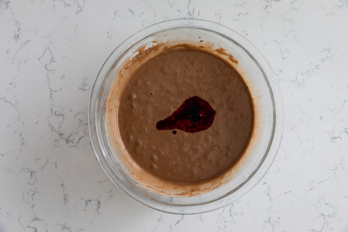 cake batter in bowl with red food coloring