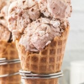 three scoops of ice cream in an ice cream waffle cone with words on the photo