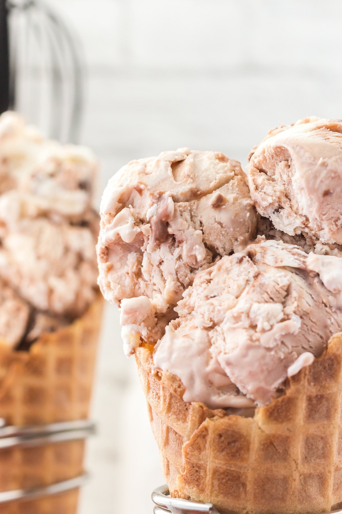 three scoops of ice cream in an ice cream waffle cone