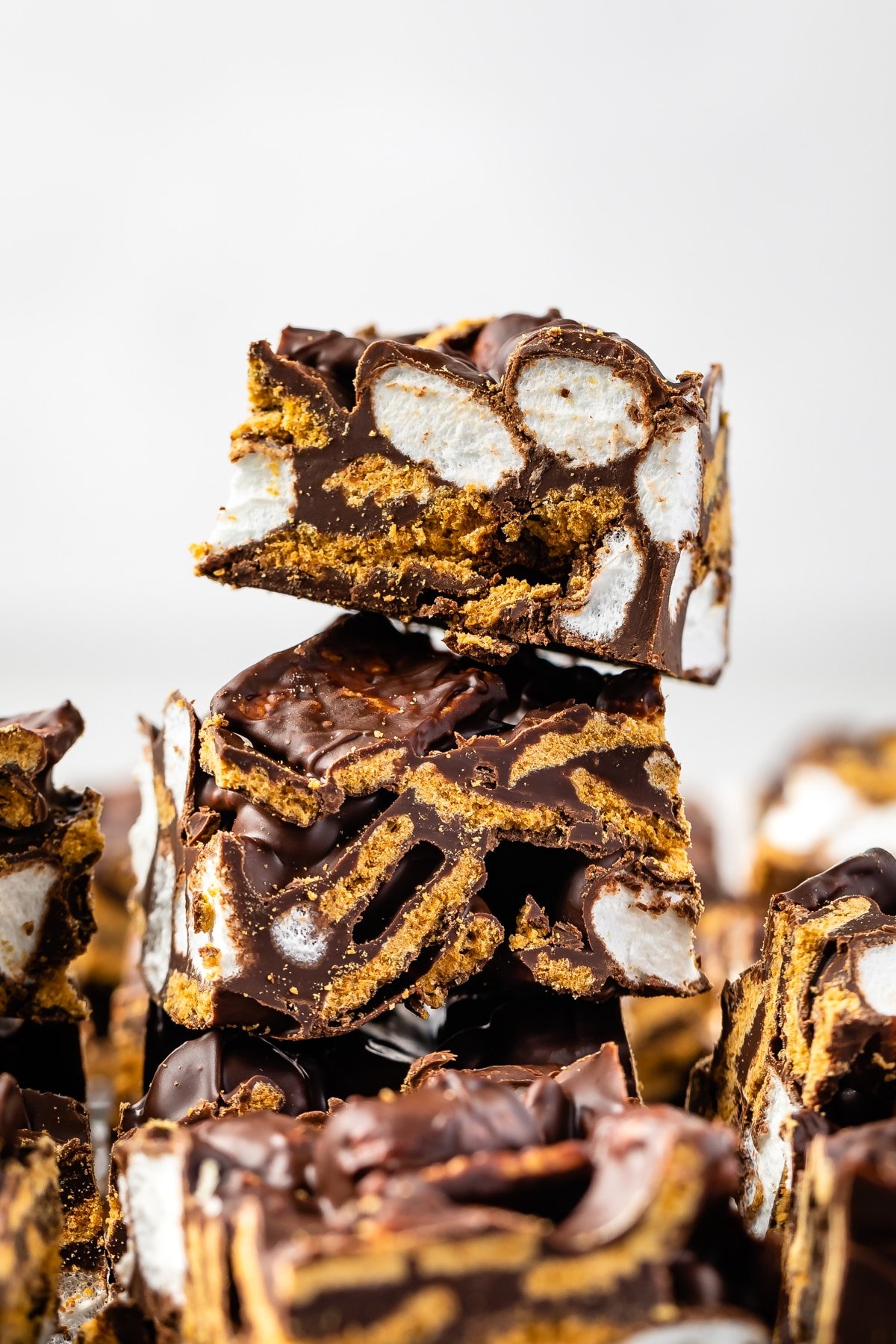 stacked s'mores bars that are sliced to see the marshmallows on the inside