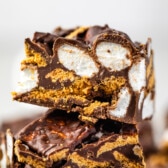 stacked s'mores bars that are sliced to see the marshmallows on the inside