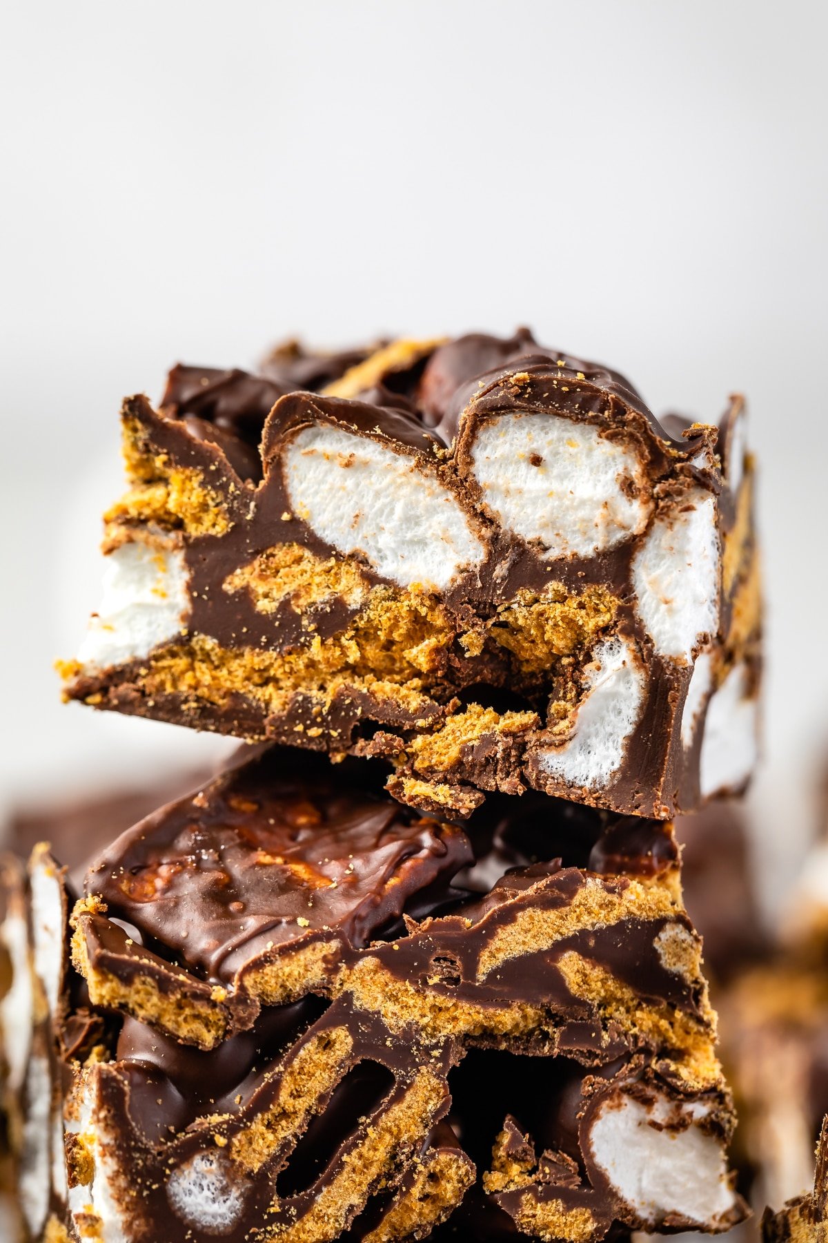 stacked s'mores bars that are sliced to see the marshmallows on the inside