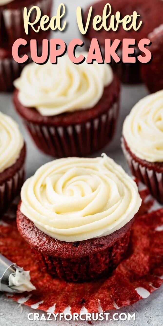 Red velvet cupcakes topped with cream cheese frosting and recipe title on top of photo