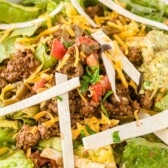 taco salad in bowl with words on photo.