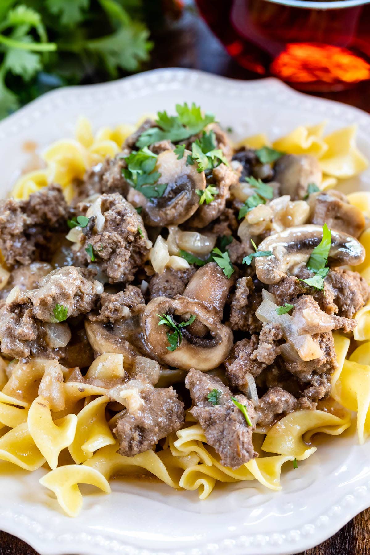 mushrooms and meat on pasta in a white plate