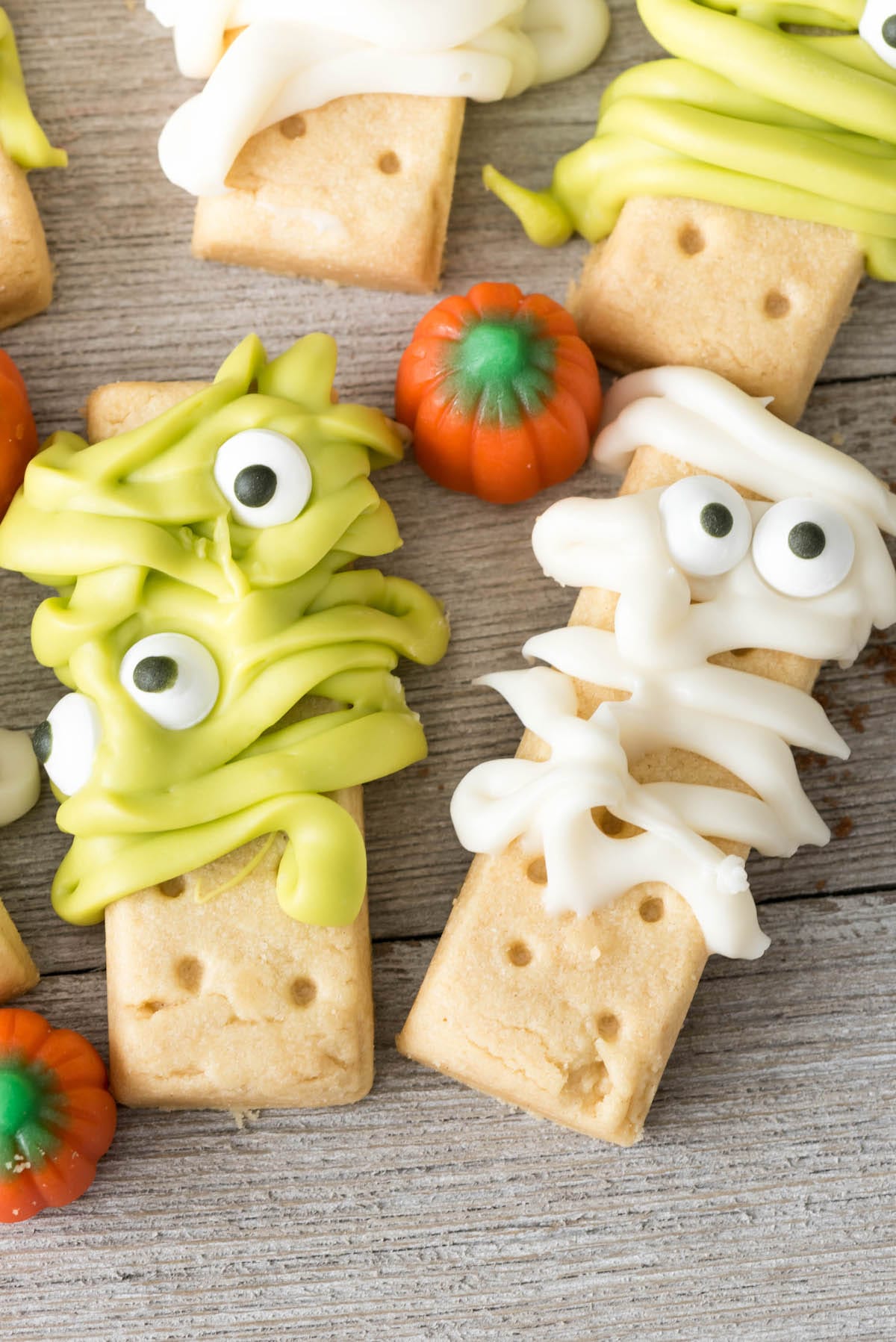 monster and mummy decorated cookies on a white board