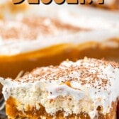 a slice pumpkin dessert sitting on a white plate with white frosting and pumpkin topping and words on the photo