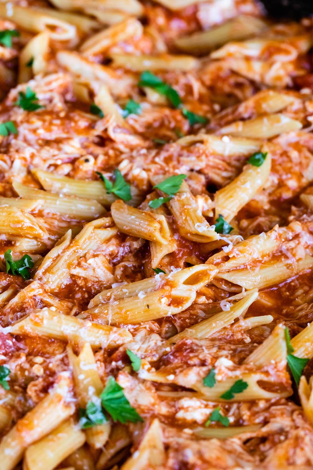 unclose photo of pasta mixed with herbs and sauce