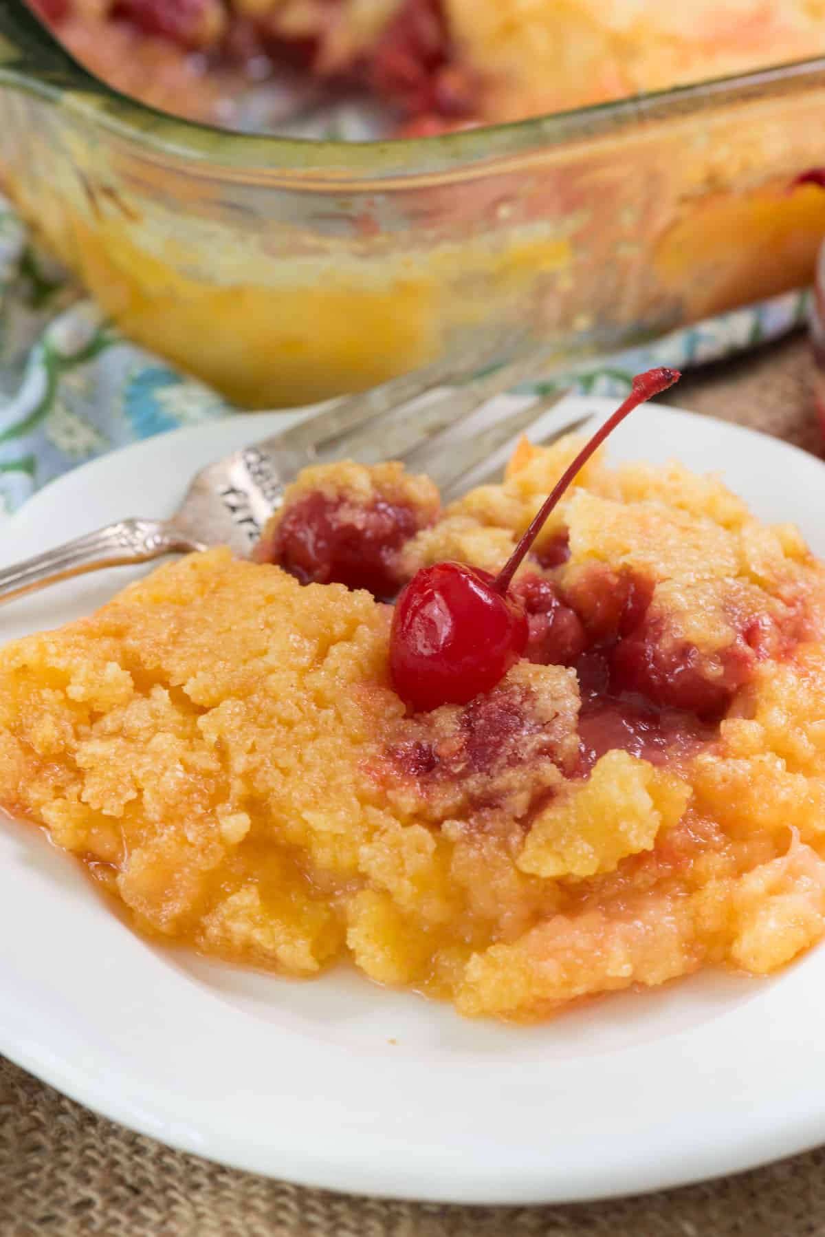 pineapple cake on white plate with cherry