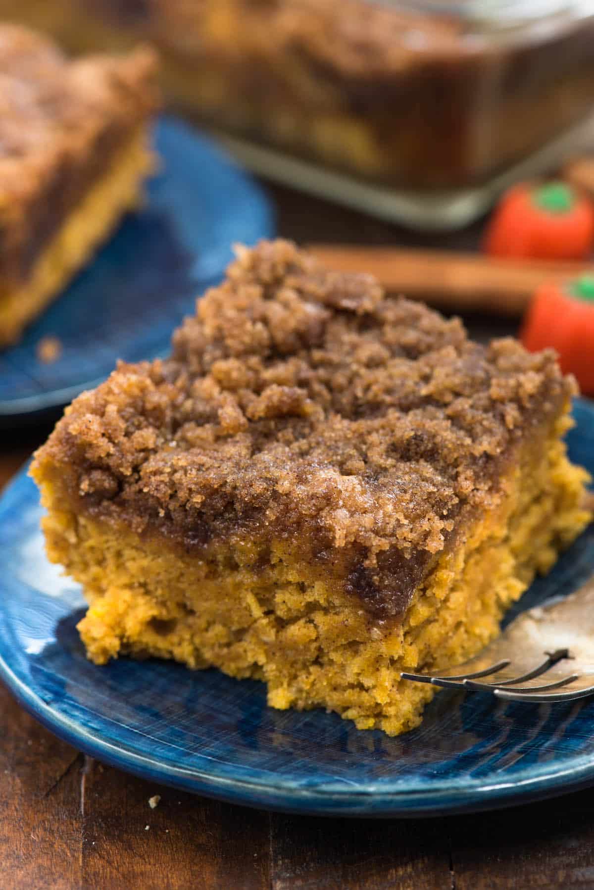 coffee cake on a dark blue plate next to a fork