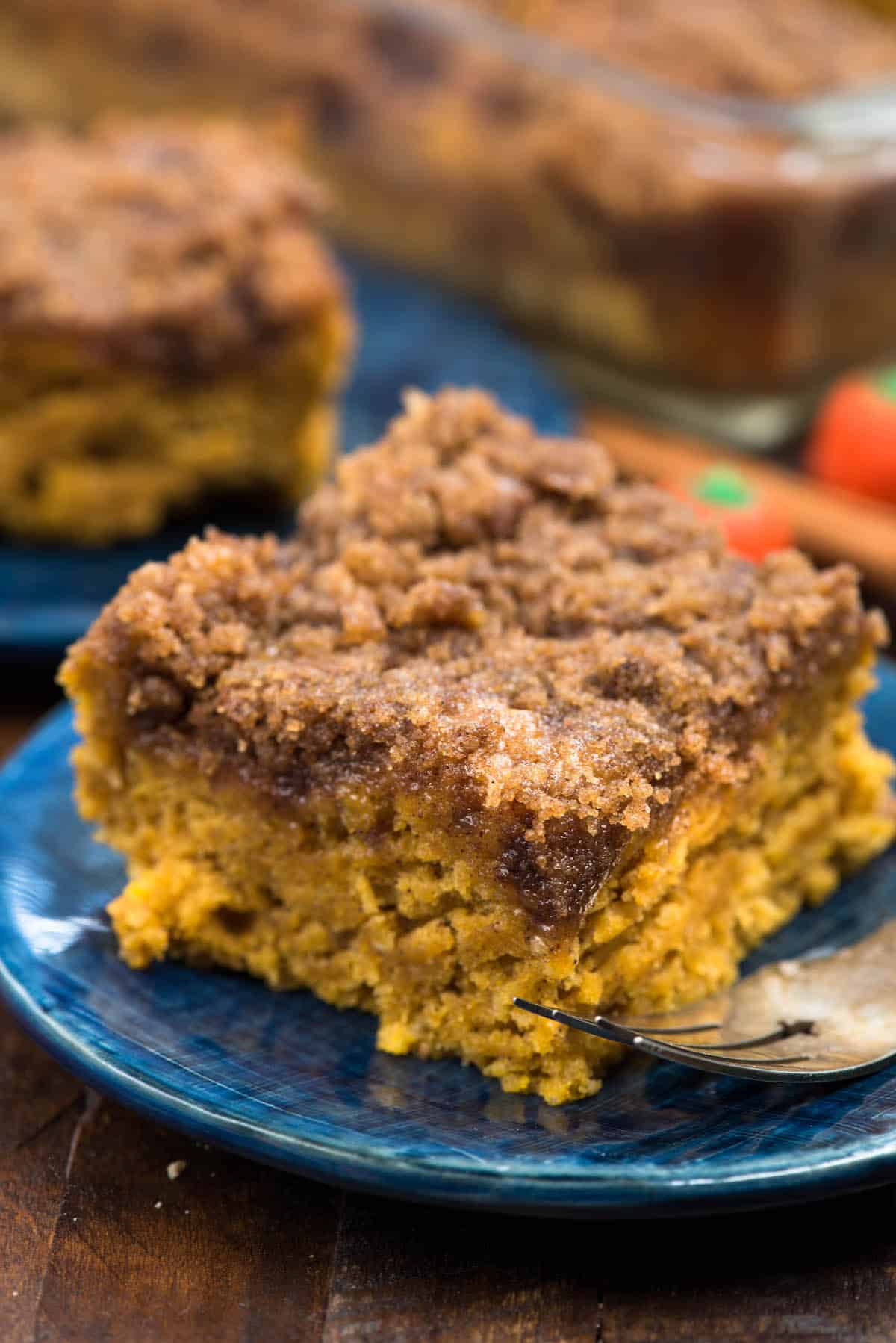 coffee cake on a dark blue plate next to a fork