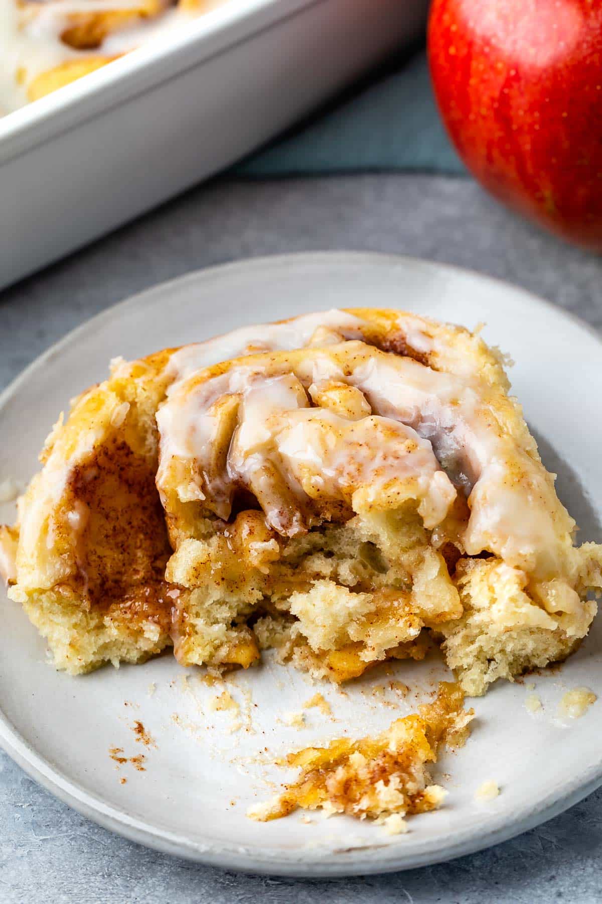 half of a cinnamon rolls on a grey plate