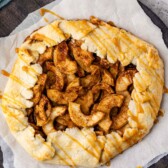 apple dessert cooked on parchment paper with caramel drizzled on top