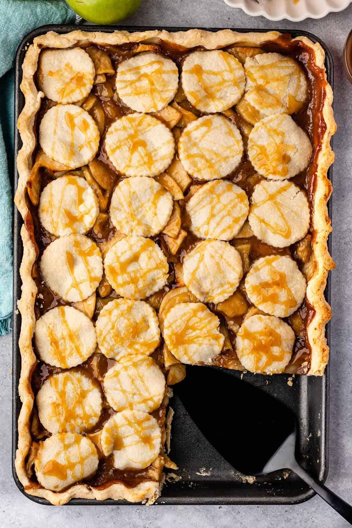 slab pie in a black pan with a slice taken out of it