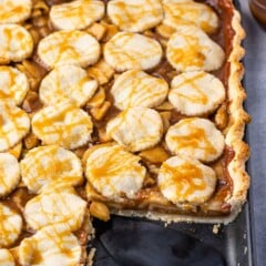 slab pie in a black pan with a slice taken out of it