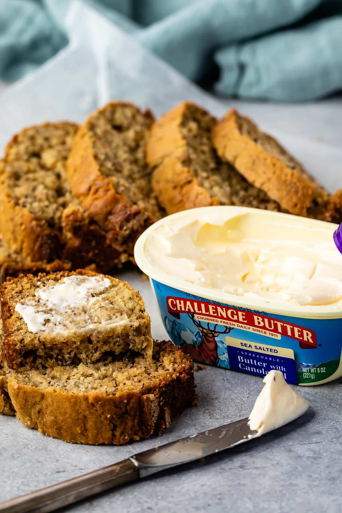 challenge butter with canola oil and knife and bread