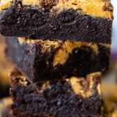 stacked black and yellow swirl brownies with words on the top