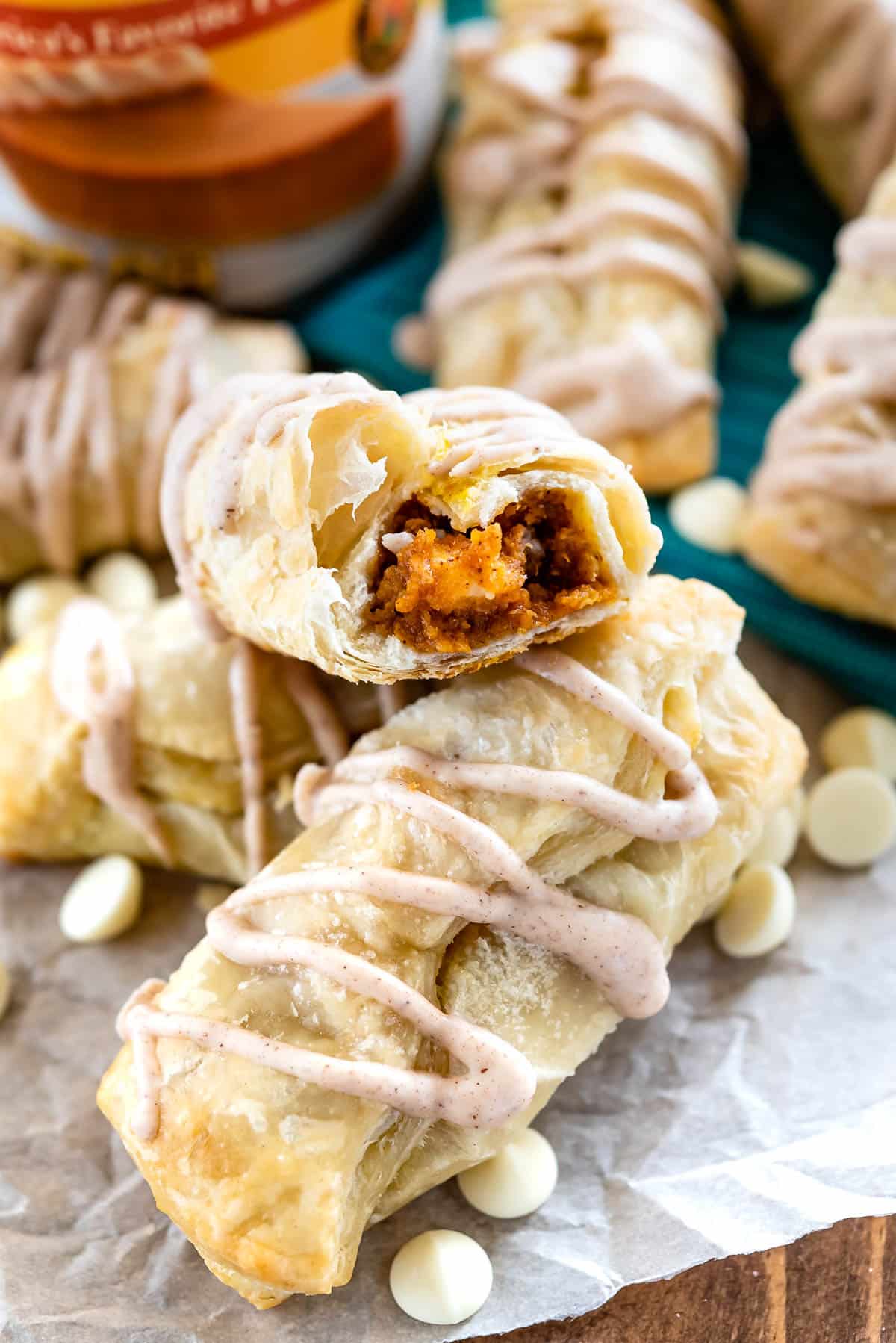 croissant cut in half with white chocolate drizzle on top and pumpkin in the middle