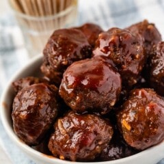 multiple meatballs stacked in a white bowl