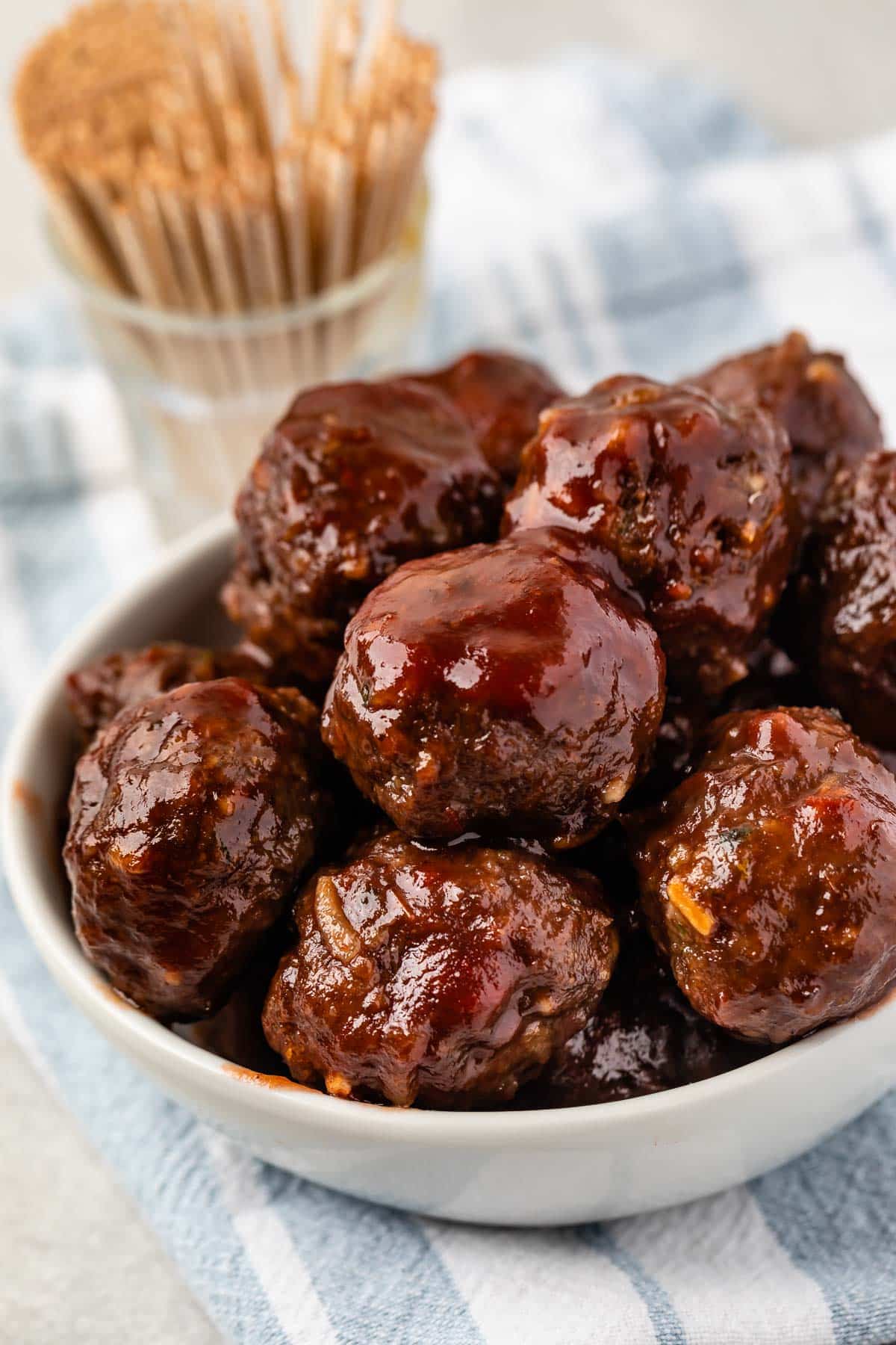 multiple meatballs stacked in a white bowl