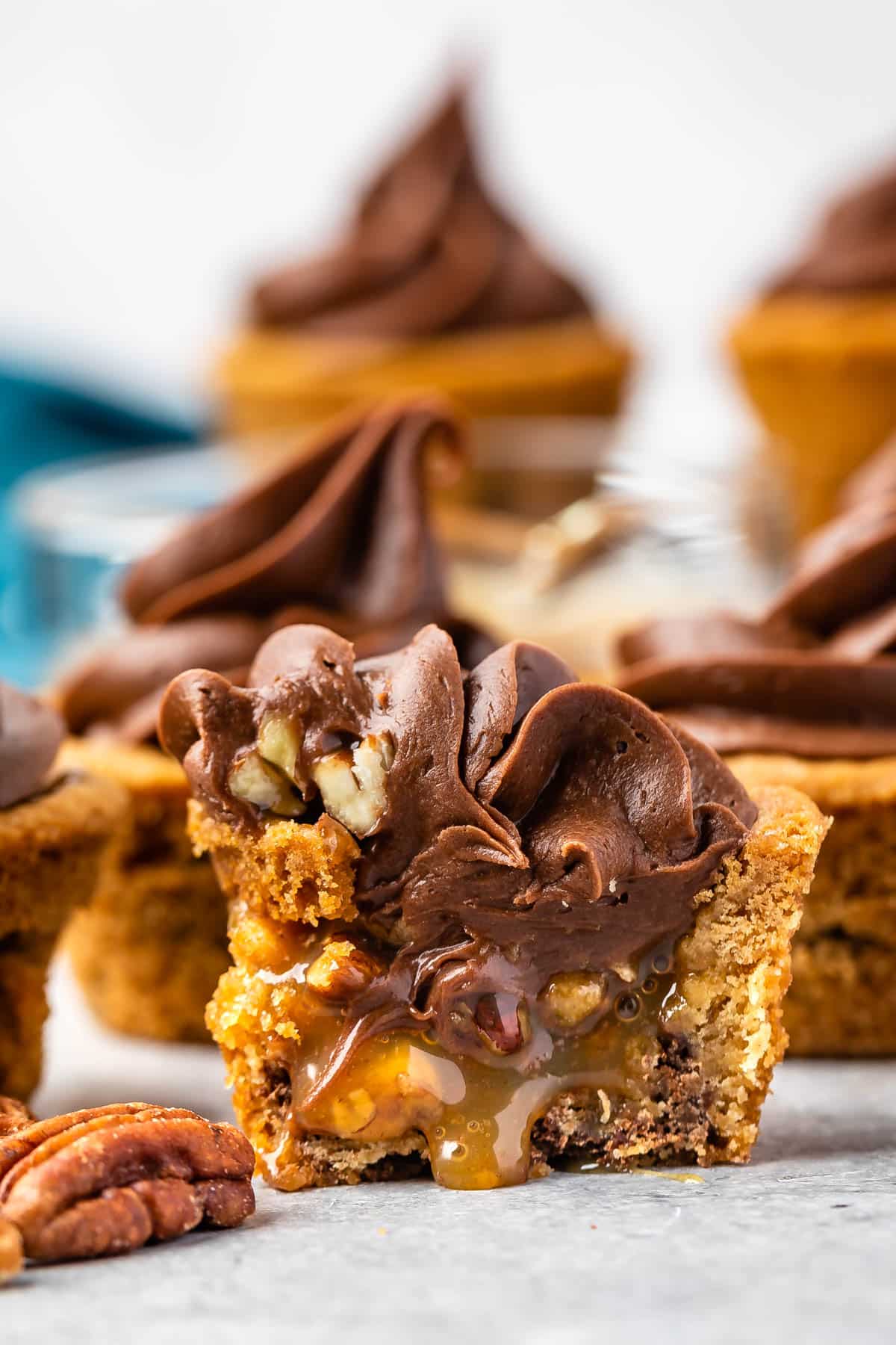 turtle cup cut in half showing caramel sauce and chocolate frosting