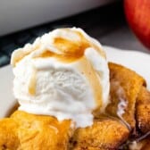 apple dumpling in a white plate with vanilla ice cream on top and words on top of the image