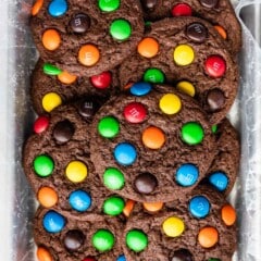 stacked chocolate cookies with colorful m&ms baked in