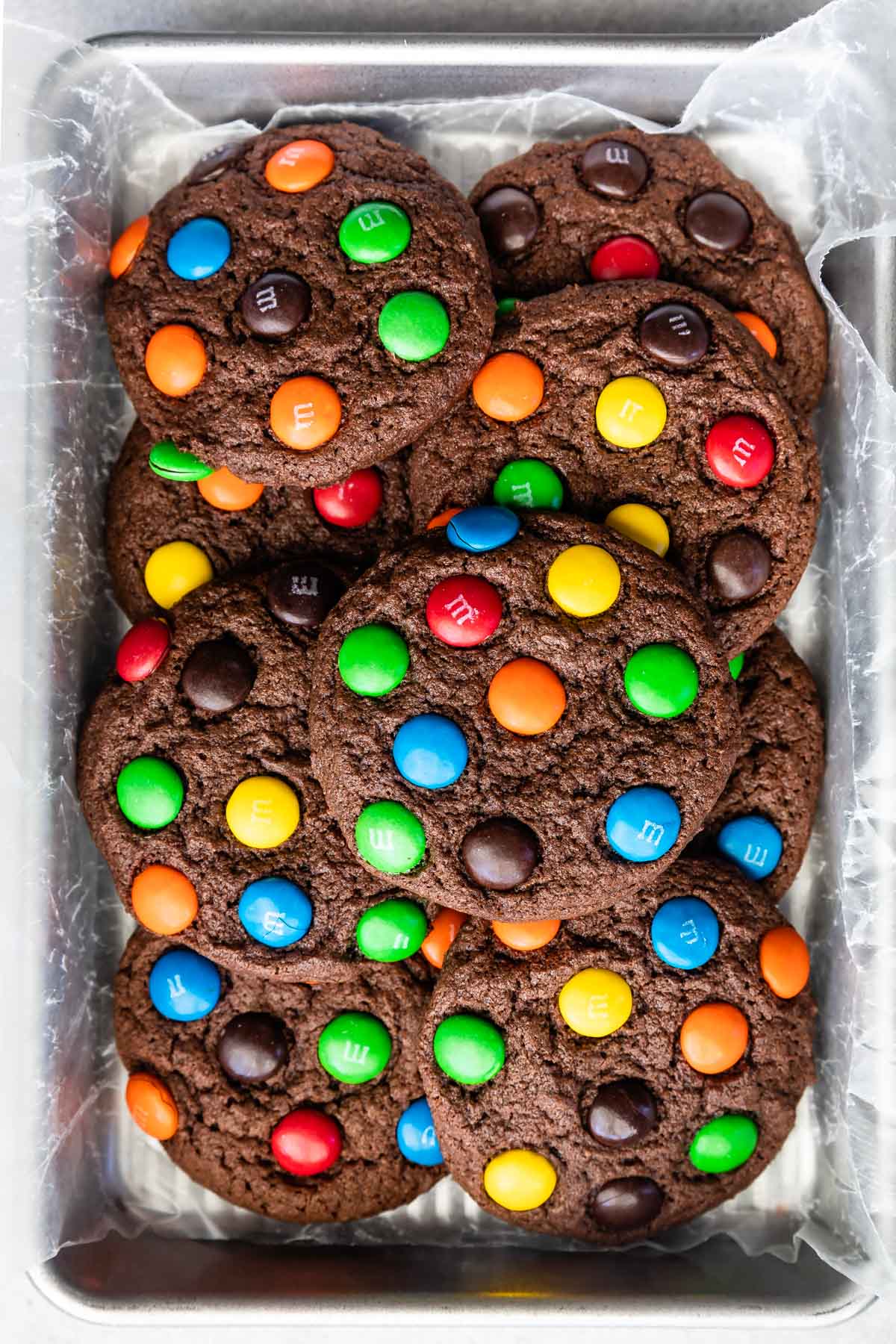 stacked chocolate cookies with colorful m&ms baked in