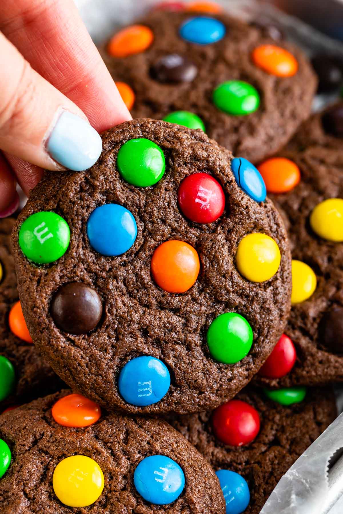 stacked chocolate cookies with colorful m&ms baked in