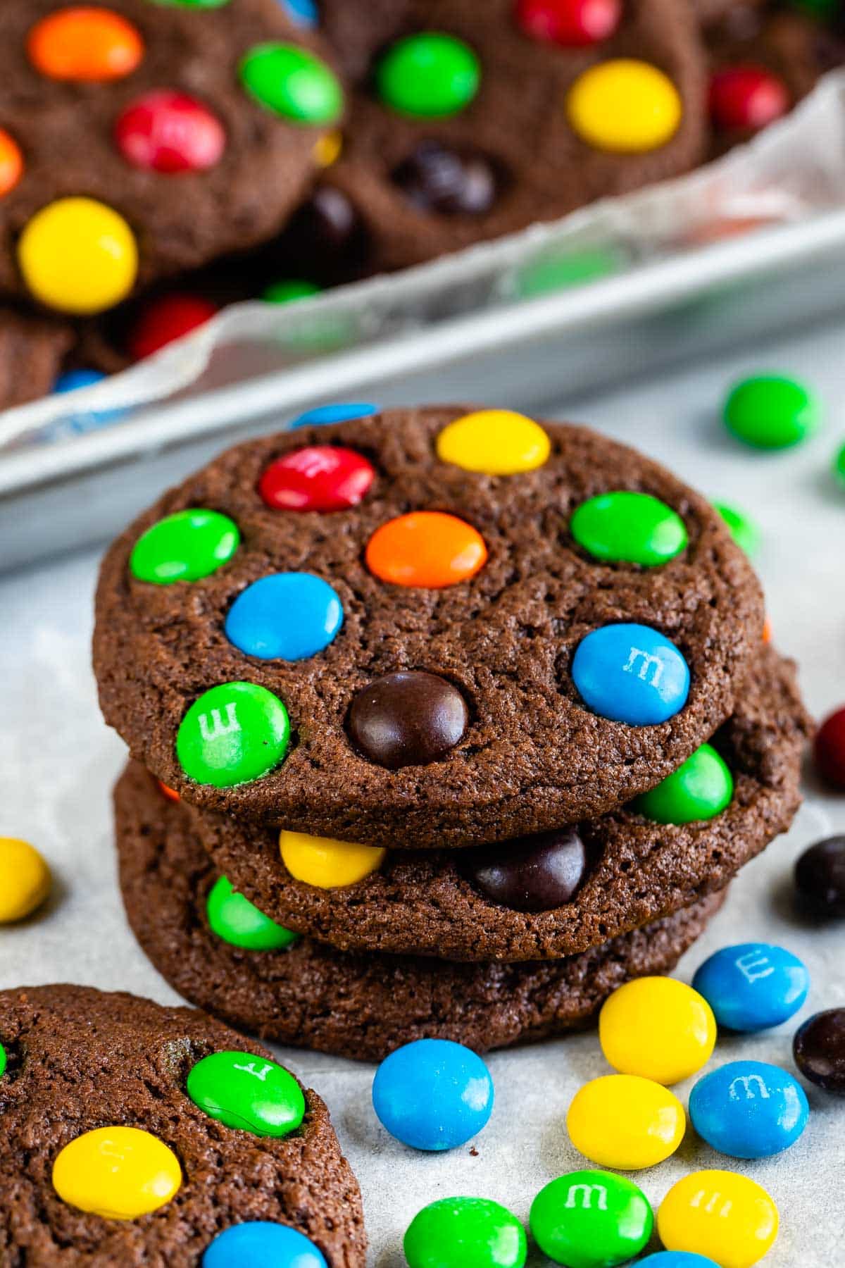 stacked chocolate cookies with colorful m&ms baked in