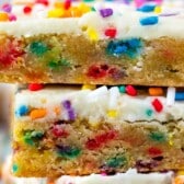 stacked cookie bars with colorful rainbow sprinkles baked in and sprinkled on top with words on the image