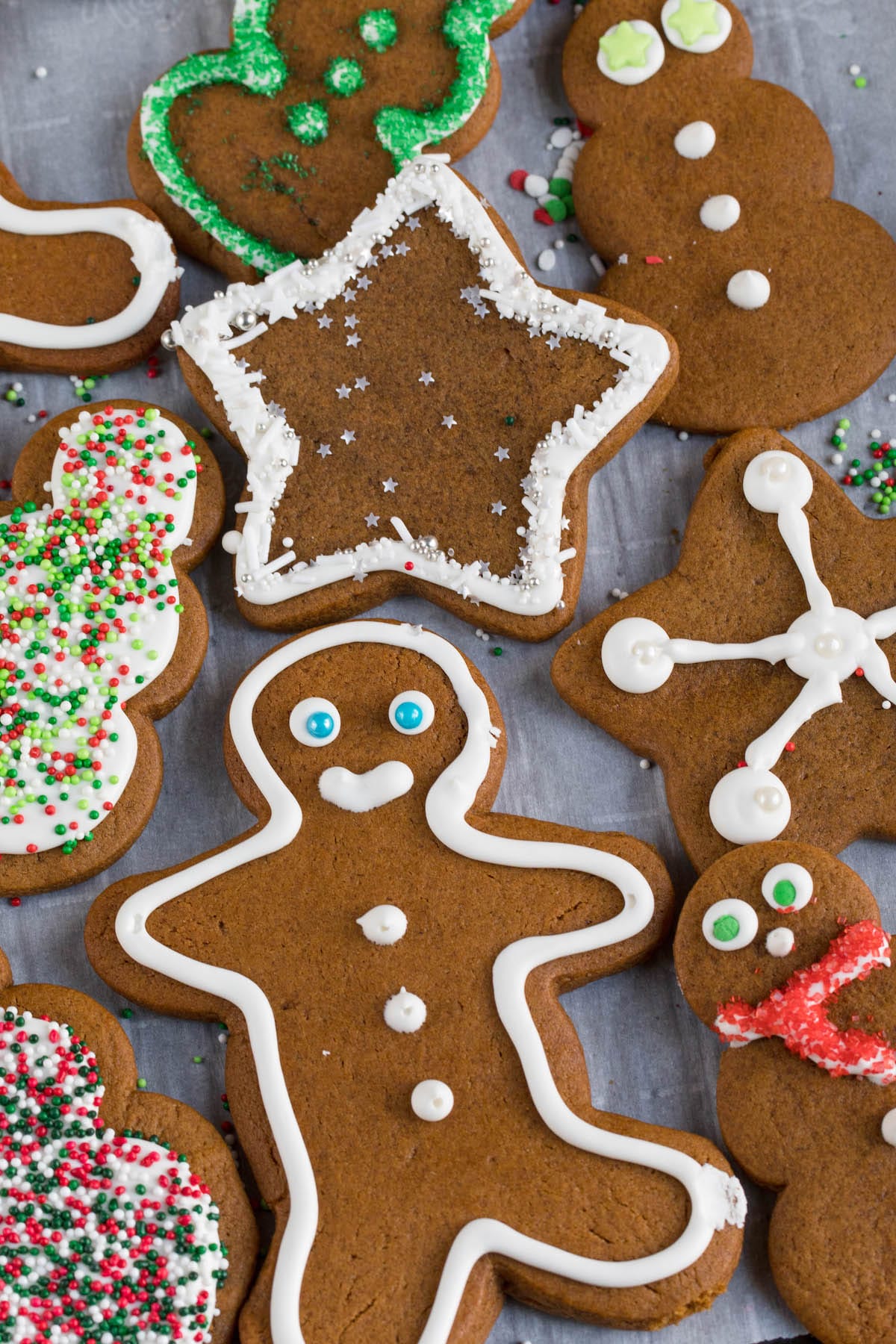 gingerbread man, snowmen and stars cutouts of gingerbread cookie dough with royal icing