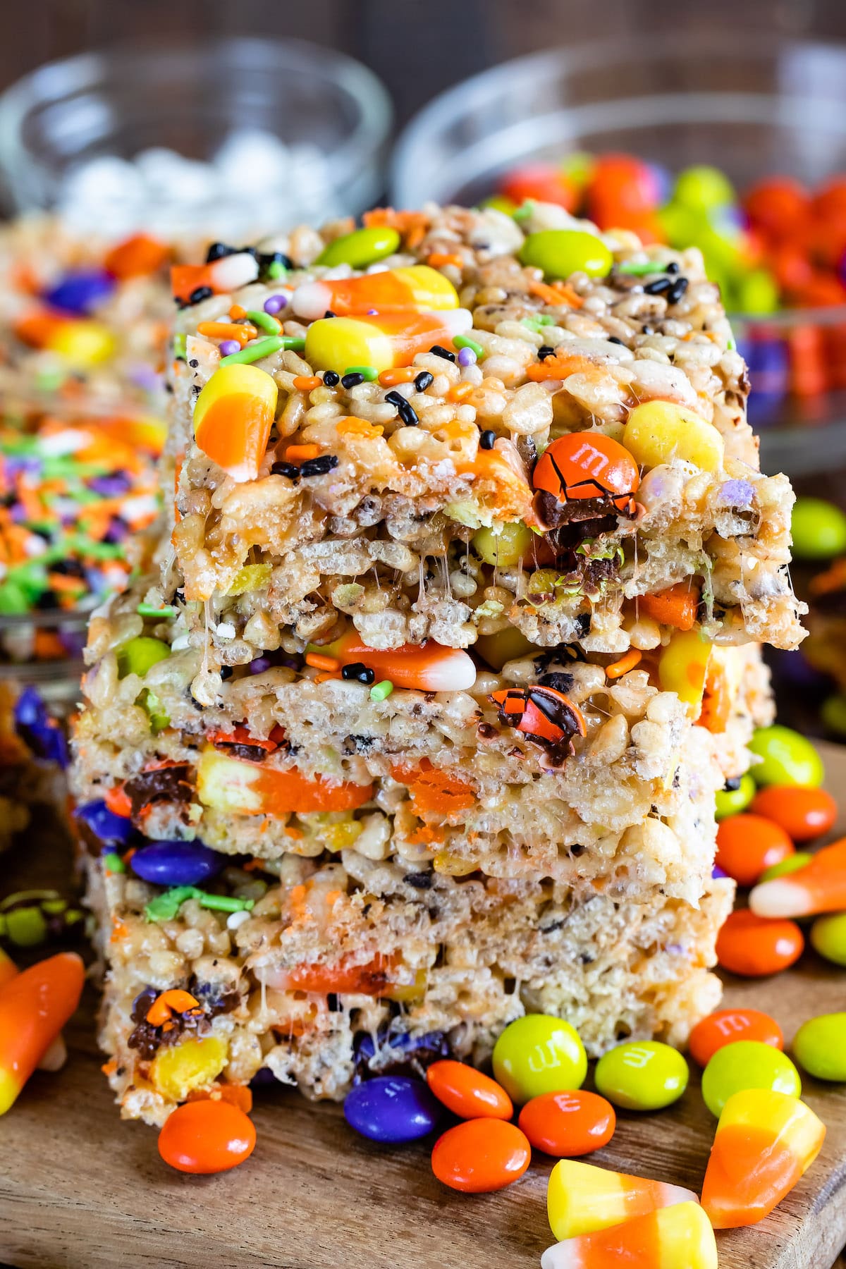 three stacked Krispie treats with m&ms and candy corn in them