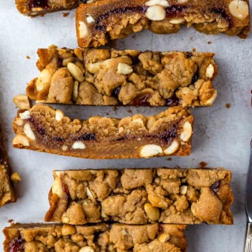 peanut butter and jelly cookie cake sliced and laid out on a countertop