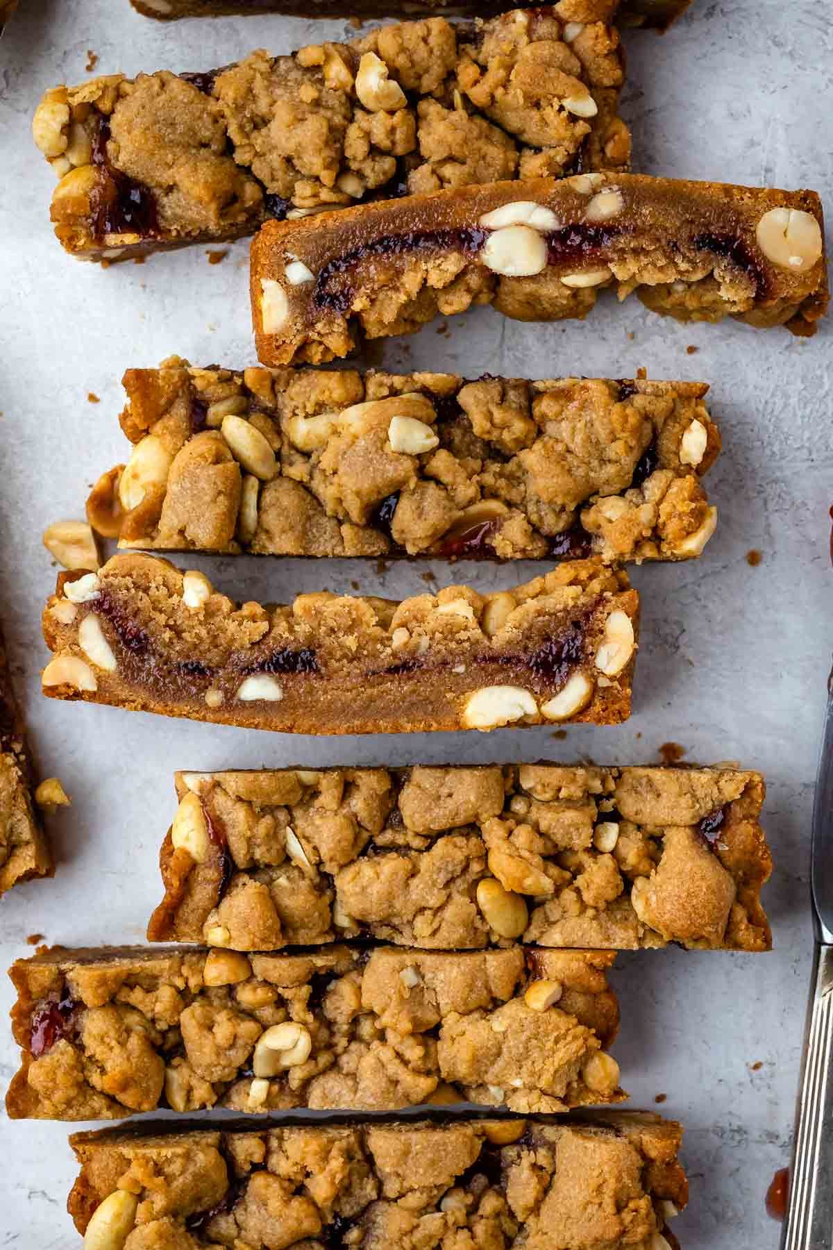 peanut butter and jelly cookie cake sliced and laid out on a countertop