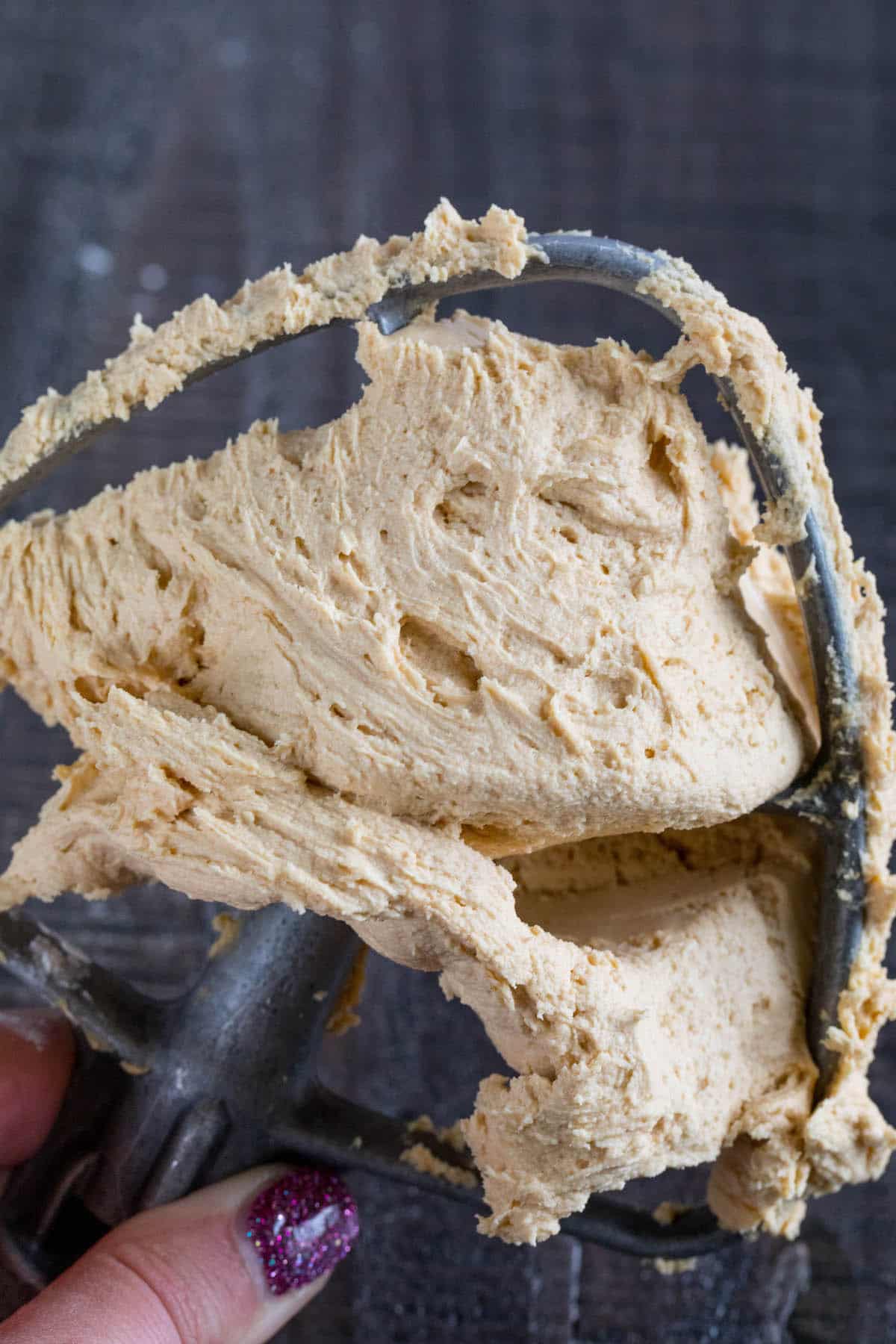 peanut butter frosting on a grey mixing arm