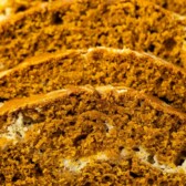 four slices of the pumpkin loaf laying on a drying rack with words on top of the image