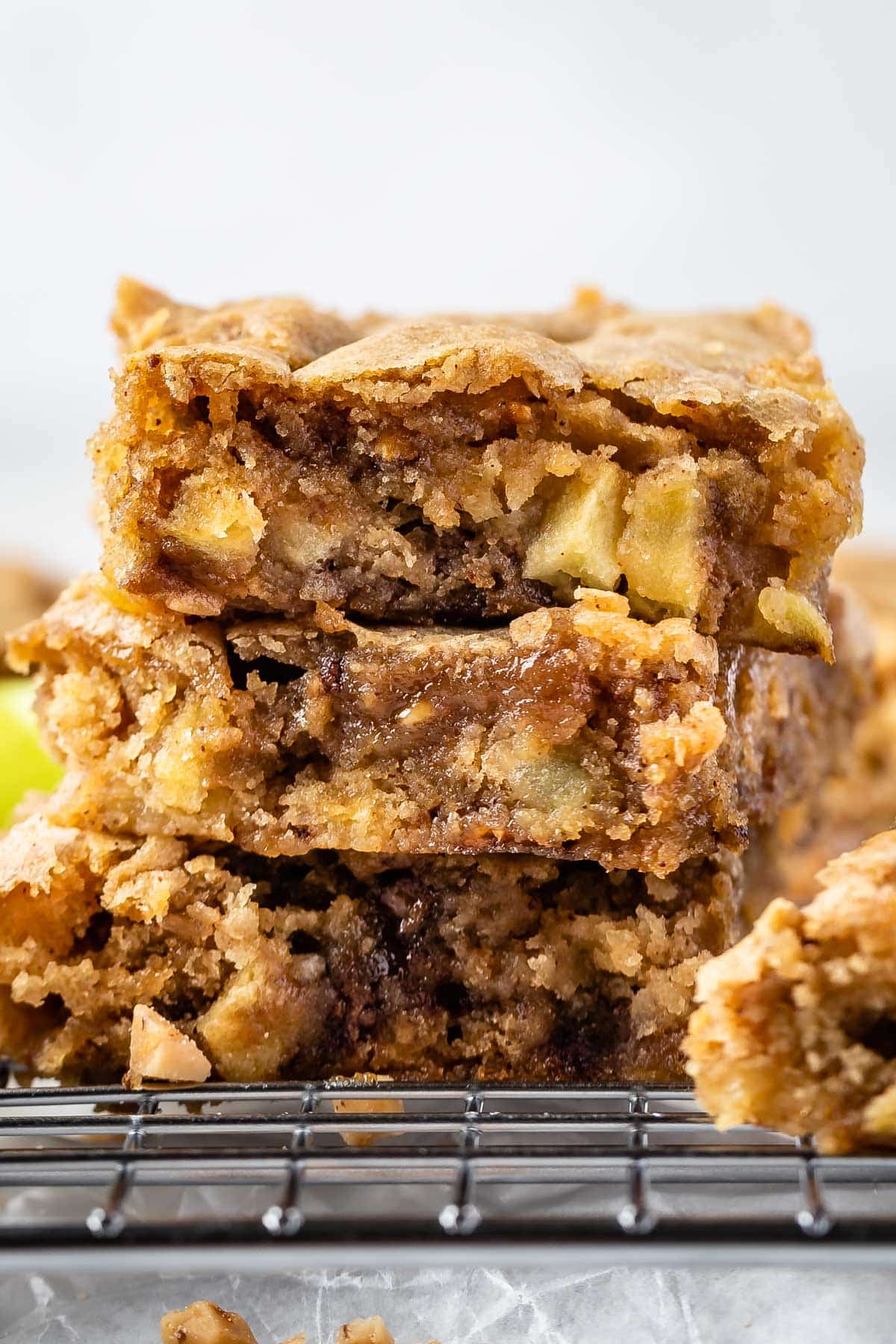 stacked toffee bars on a drying rack with apples baked in