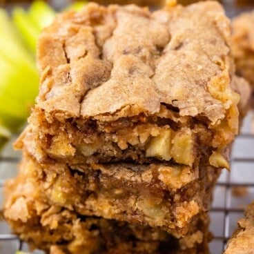 stacked toffee bars on a drying rack with apples baked in